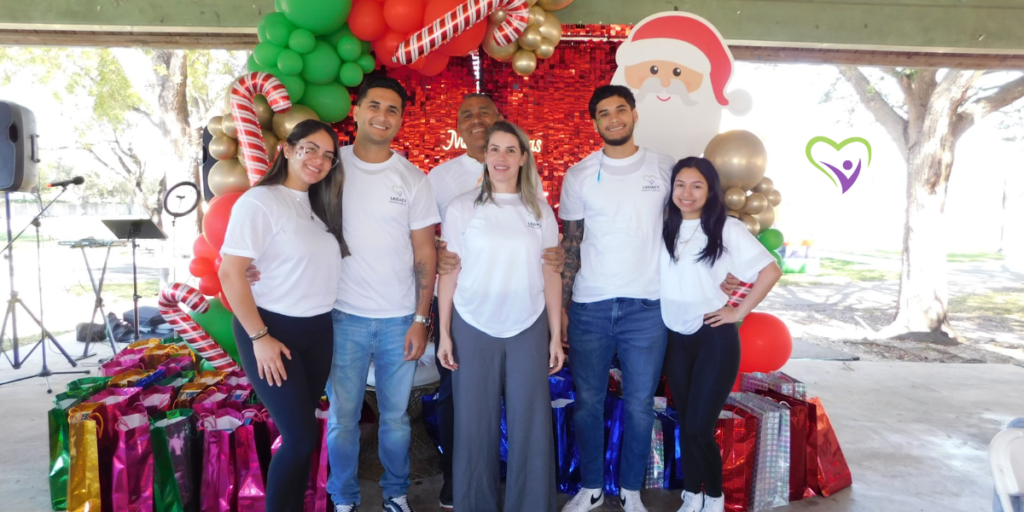 Legacy Health Care team smiling warmly and proudly wearing branded company shirts, showcasing their professionalism and unity.